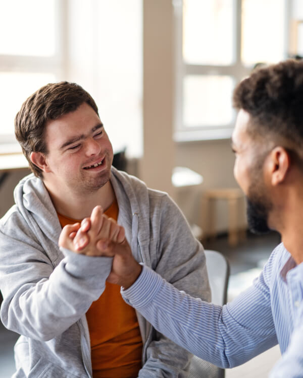Young man with down syndrome and his carer